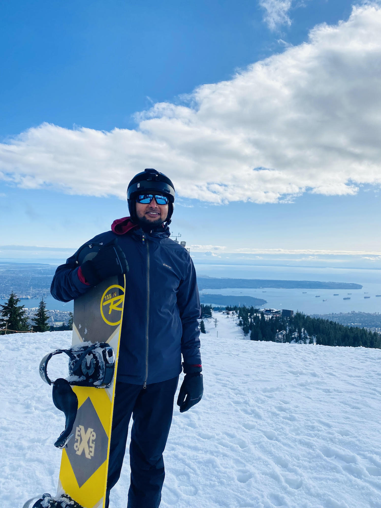 UBC MBA student Naveen Singh smiles atop Grouse Mountain 